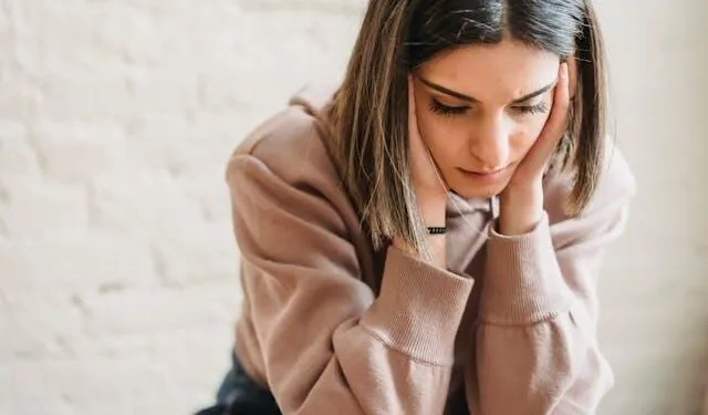 A stressed woman looking down