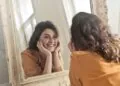 A woman looking at herself in the mirror