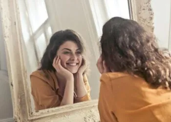 A woman looking at herself in the mirror