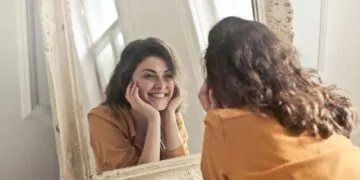 A woman looking at herself in the mirror